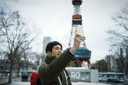 观光旅游拿着手机拍照记录的青年男性图片