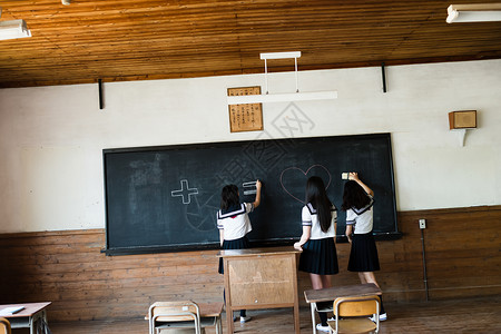在黑板上涂鸦的的高中女孩图片