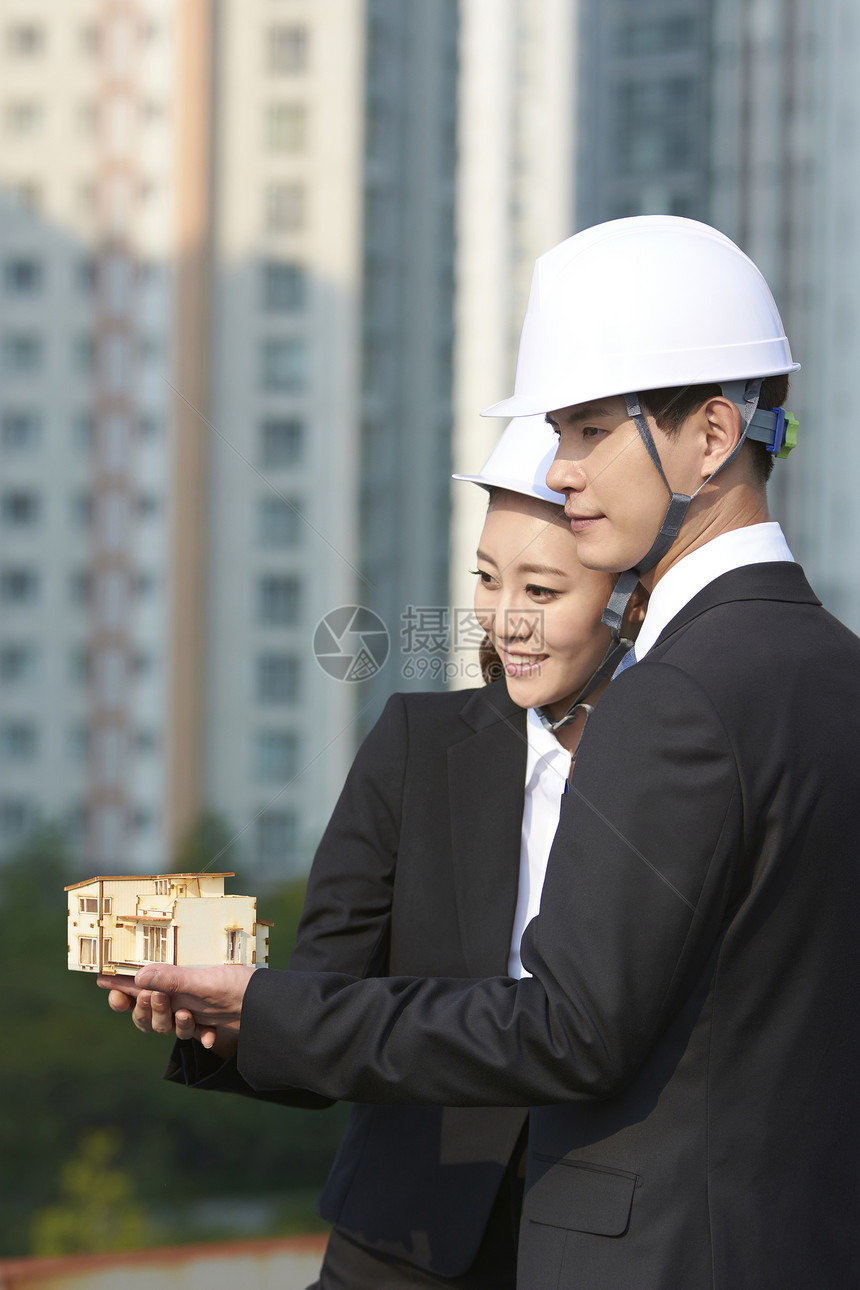 建筑工地上戴安全帽的商务人士图片
