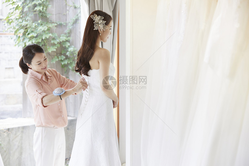 快乐30岁年轻女子婚纱店婚纱婚礼策划新婚夫妇婚礼准备图片