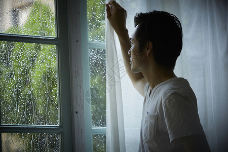 下雨天在室内的孤独男性高清图片