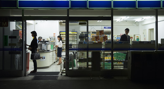 日本便利店夜晚在便利店购物的顾客背景