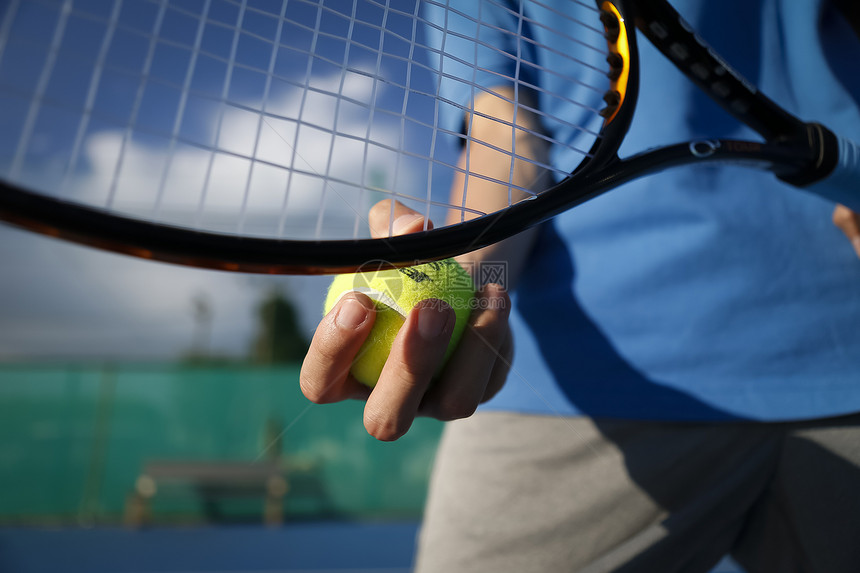 网球运动员手拿网球准备击球图片