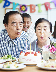 纪念日吹蜡烛的夫妇图片