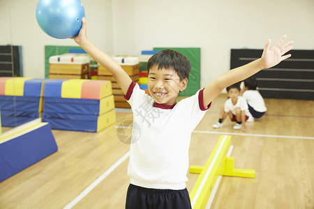 体操教室练习平衡木的小男孩图片