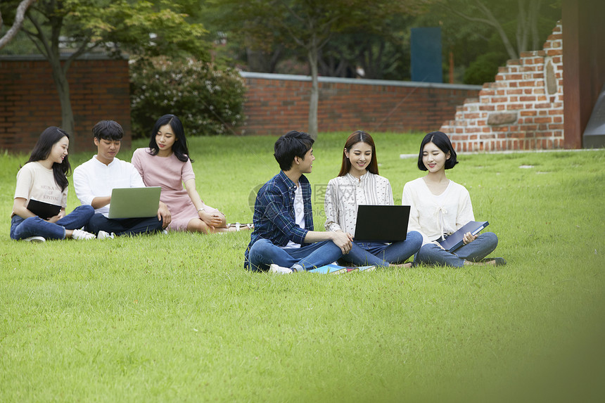 青年大学生在草坪上休息的形象图片