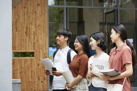 校园里行走的青年大学生背景图片