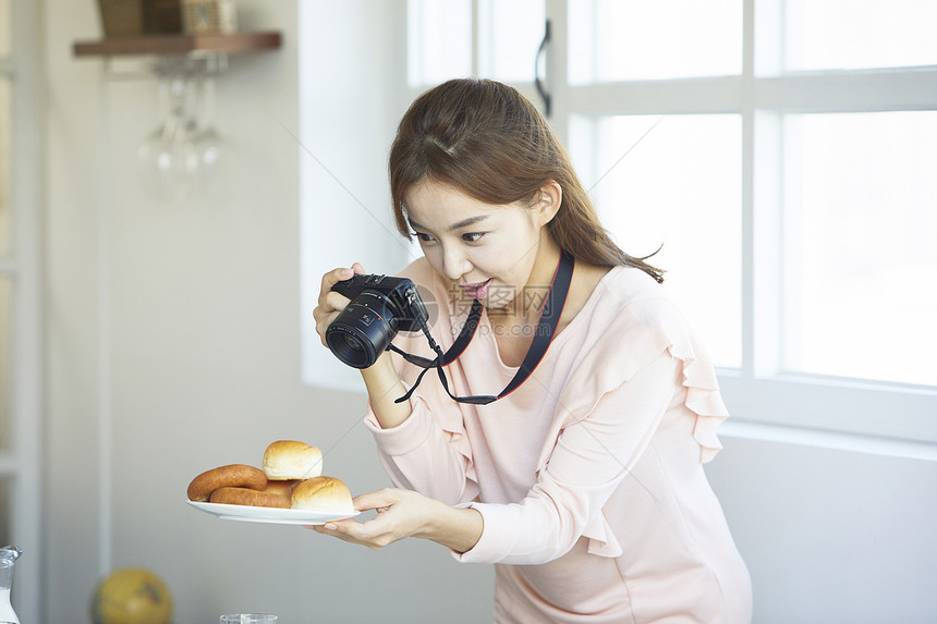 居家女性用照相机拍菜图片