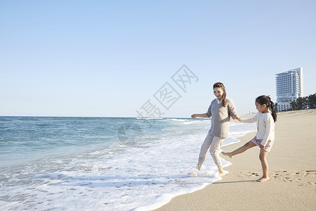 海边沙滩上玩耍的母女图片