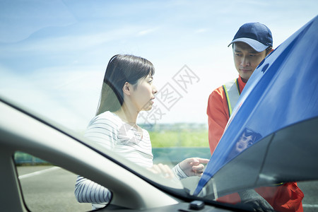 女司机为道路救援服务人员讲解故障问题图片