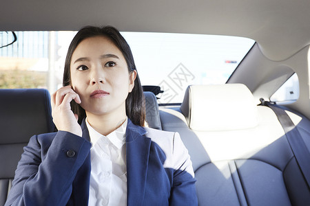 坐在车上打电话的青年女性图片