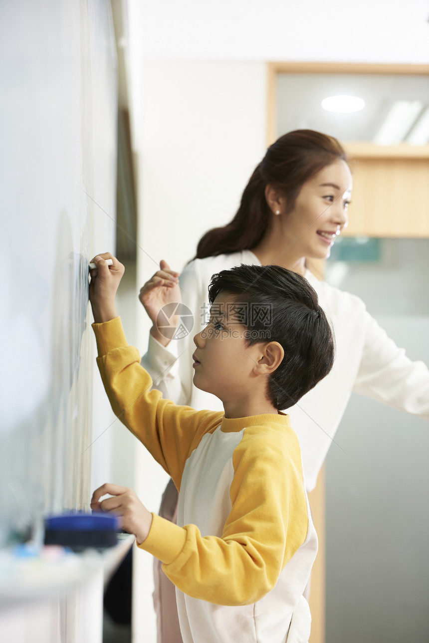 小学生在黑板上写字图片