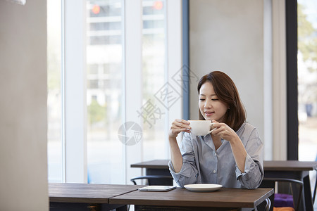 喝咖啡休息的年轻女子图片