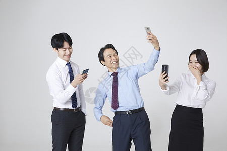 三人商务人士用手机图片