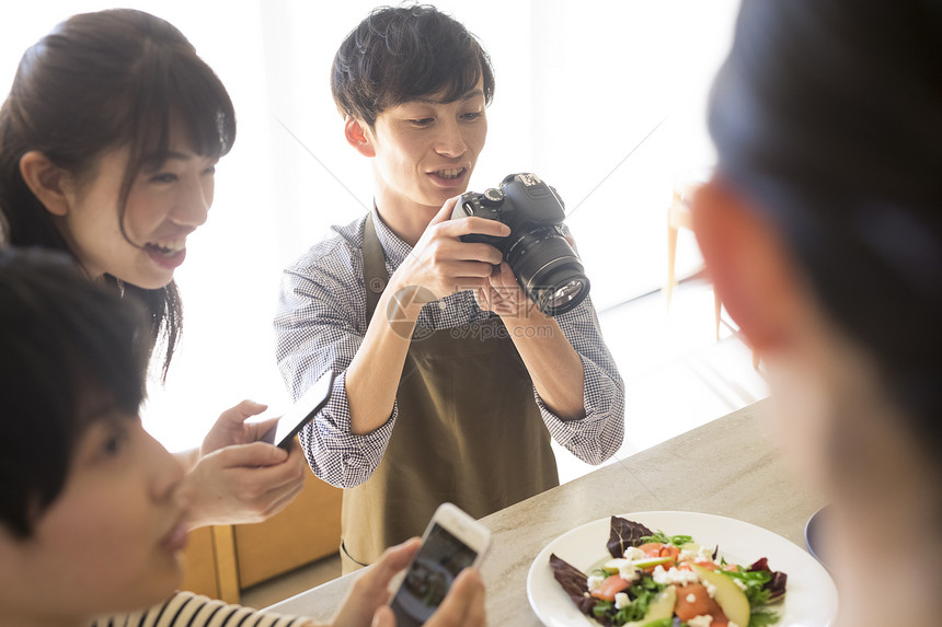 笑脸微笑青年拍摄食物的男女图片