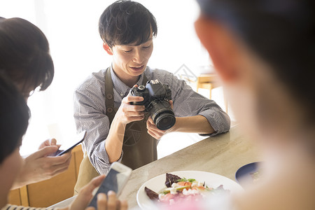 笑脸微笑青年拍摄食物的男女图片