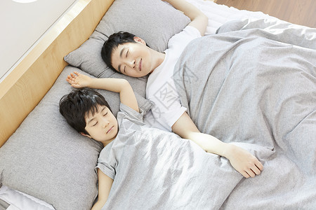 躺在床上熟睡的父子俩图片