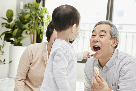 客厅里祖父祖母陪孙子吃零食图片