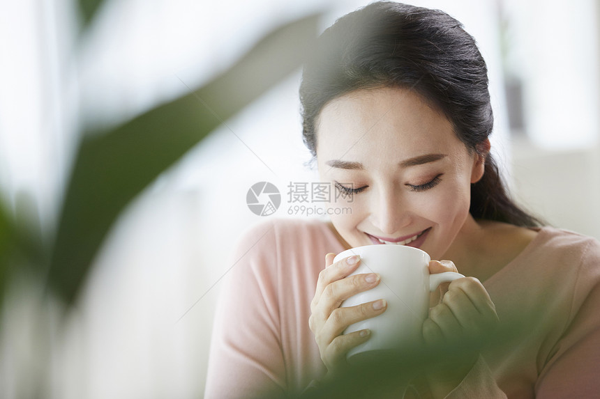 低头喝咖啡的青年女性图片
