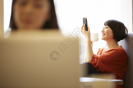 咖啡馆放松看手机的年轻女子图片