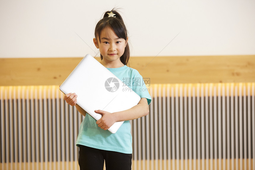 儿童手拿笔记本电脑图片