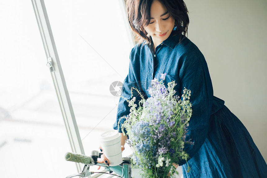 年轻美女捧着鲜花图片