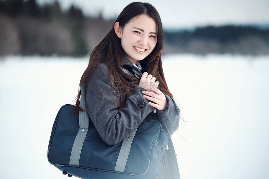 站在雪地上的制服女高中生图片