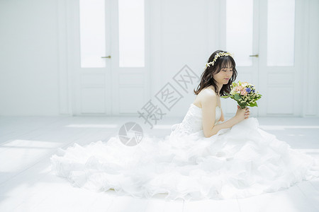 蹲坐在地上拿着花束的新娘图片