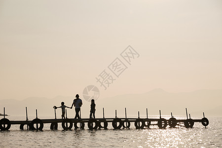 暮色湖面桥上的一家人图片