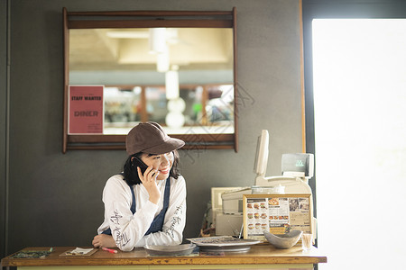 笑脸兼差美国人在一家咖啡馆工作的妇女图片