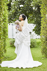 超短裙新娘穿着纯白婚纱手拿捧花背景