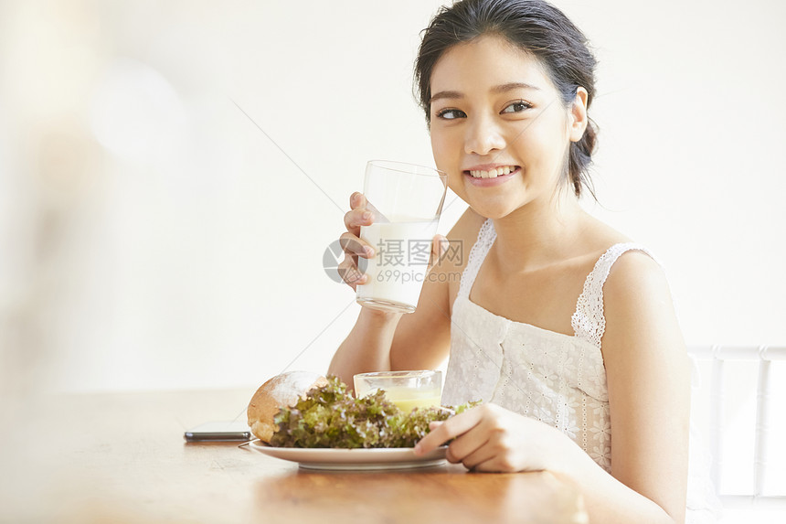 早餐拿着牛奶的女青年图片