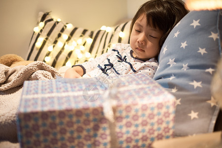 圣诞节礼物送礼日本人睡在床上的孩子背景图片
