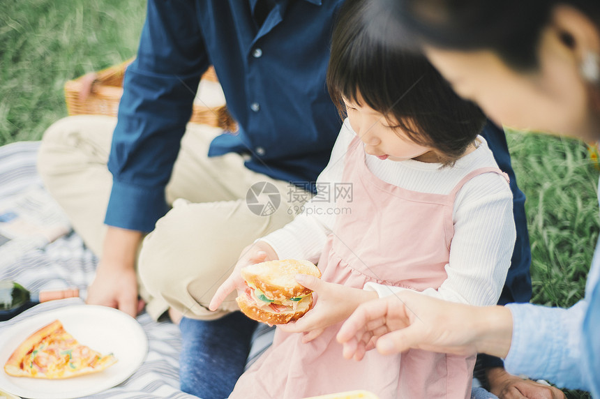 户外一家人在草地上露营吃饭图片