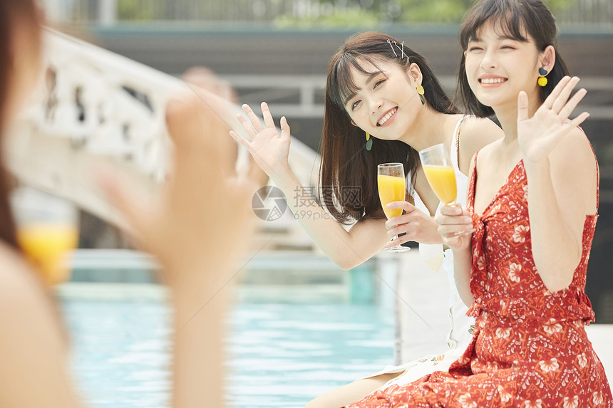 度假酒店泳池的女人喝果汁图片