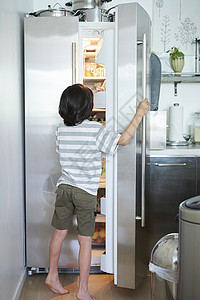 男孩打开电冰箱图片