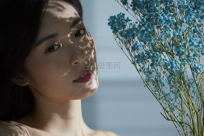 拿着干花的年轻女人图片