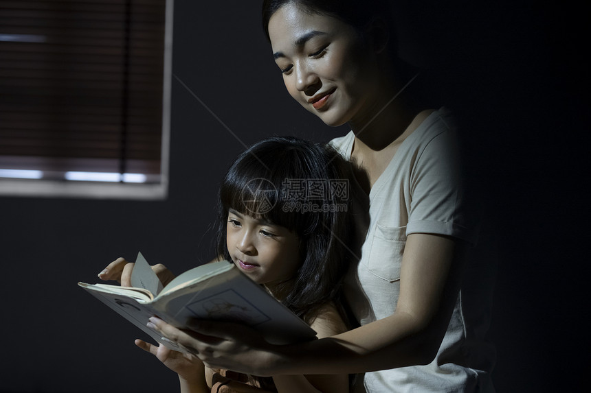 晚上妈妈给女儿阅读书籍图片