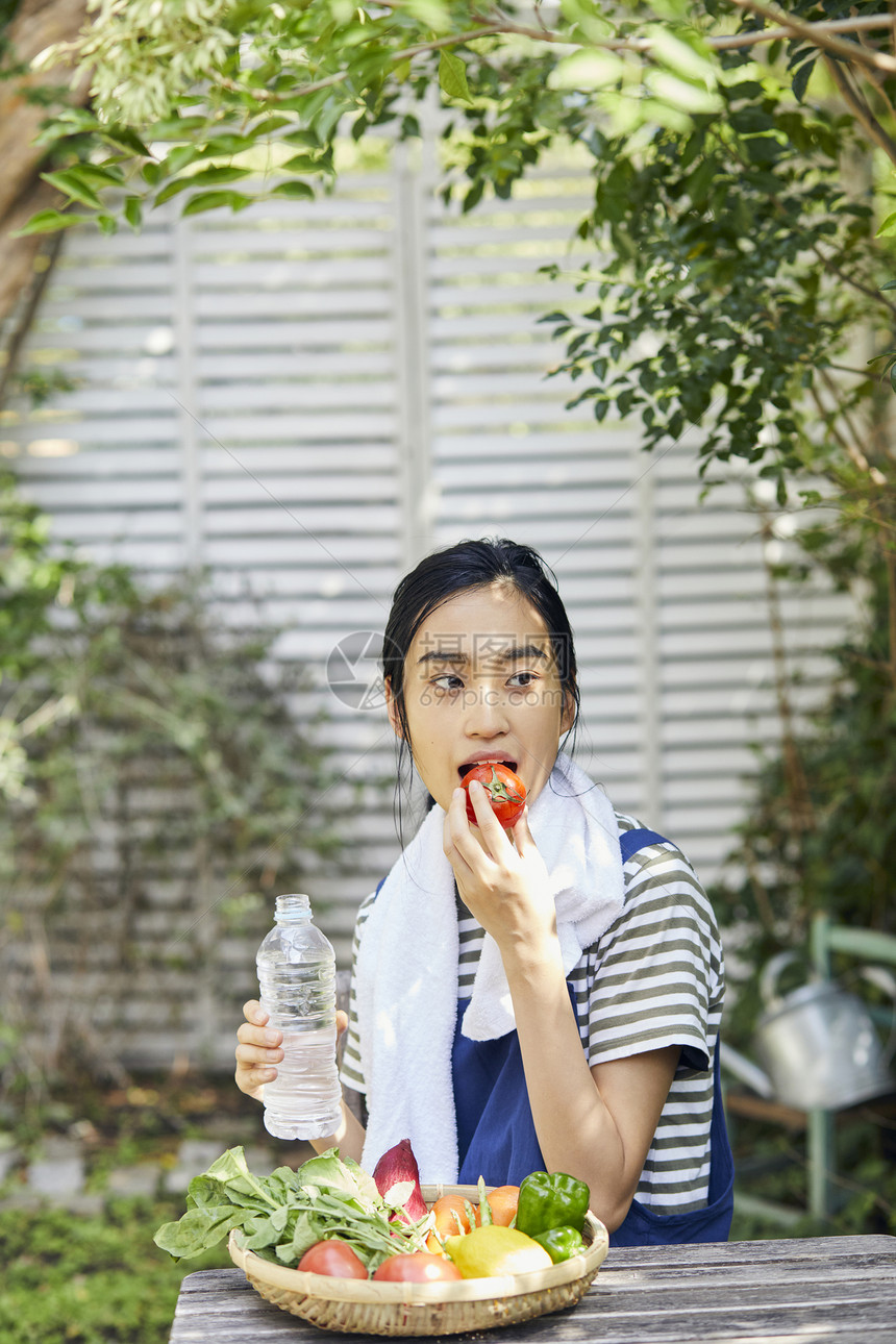 室外吃西红柿的女人图片