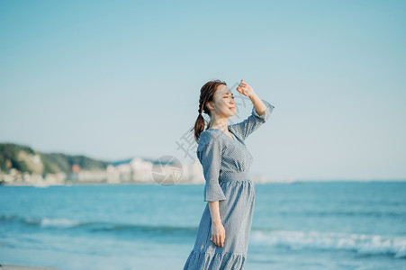 海边散步的青年女子图片