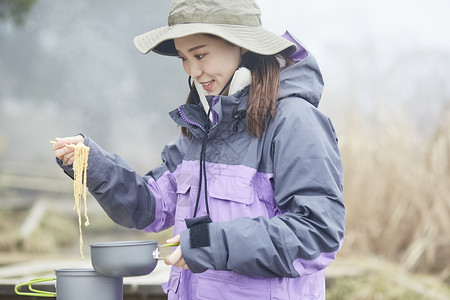 年轻女人徒步登山探险吃东西图片