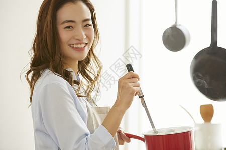 围裙锅具青年女子厨房制作料理背景
