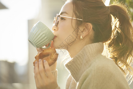 吃甜甜圈的女孩下午茶喝咖啡的青年女子背景