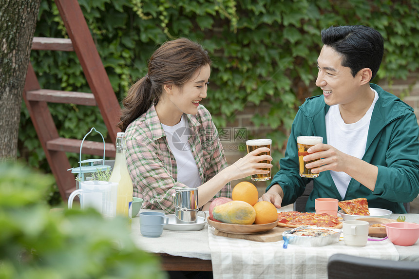 户外野餐喝啤酒的夫妇图片