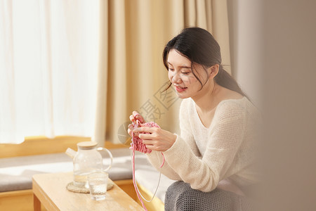 女孩织毛衣冬日女性居家织毛衣背景