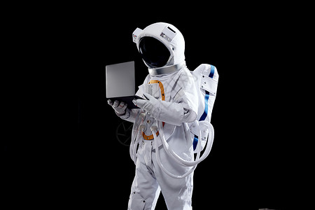 宇航员手拿笔记本电脑图片