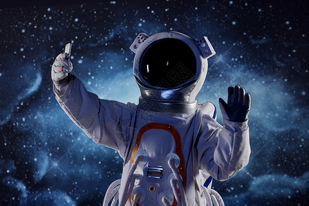 打招呼的宇航员宇航员拿着手机对着手机打招呼背景