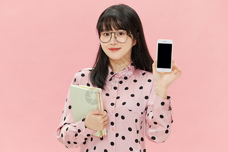 彩青春素材戴眼镜的甜美少女手拿书本和手机背景