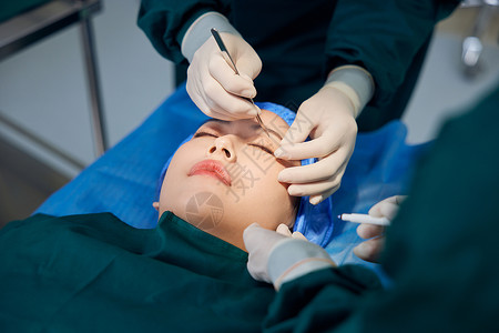 手术麻醉女性在手术台上进行整容手术背景
