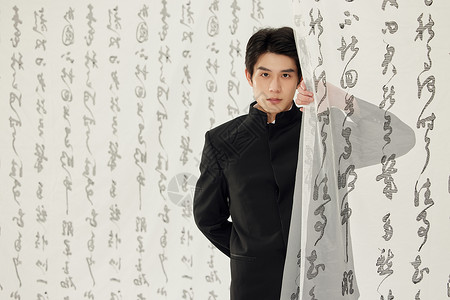 国潮水墨穿中山装的男青年站在书法背景背景